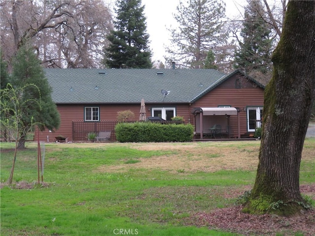 back of property with a lawn