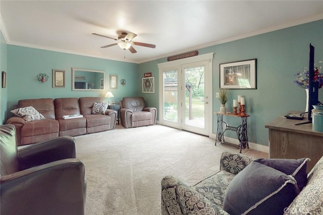 living area with baseboards, a ceiling fan, ornamental molding, and carpet flooring