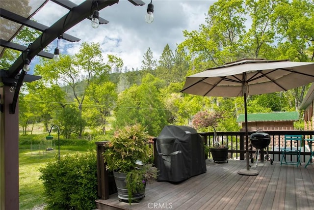 deck featuring area for grilling and a yard