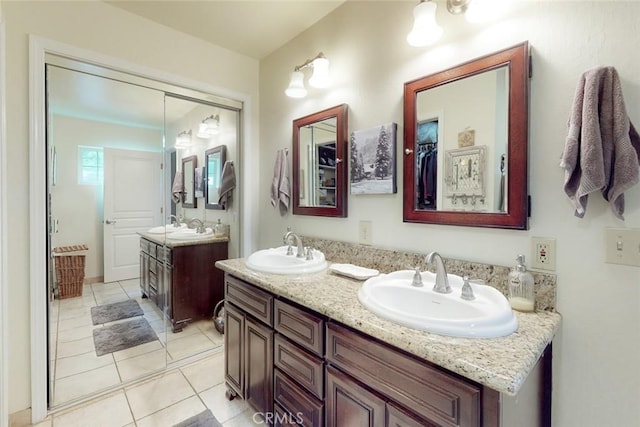 full bathroom with a sink, double vanity, and tile patterned flooring