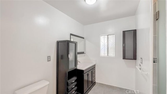 bathroom featuring tile patterned floors, toilet, and vanity