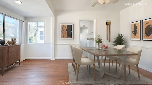 dining space with baseboards, wood finished floors, and a ceiling fan