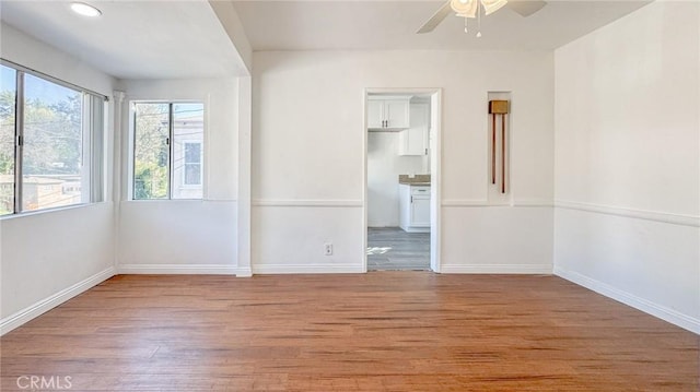 spare room with a ceiling fan, recessed lighting, baseboards, and light wood-type flooring