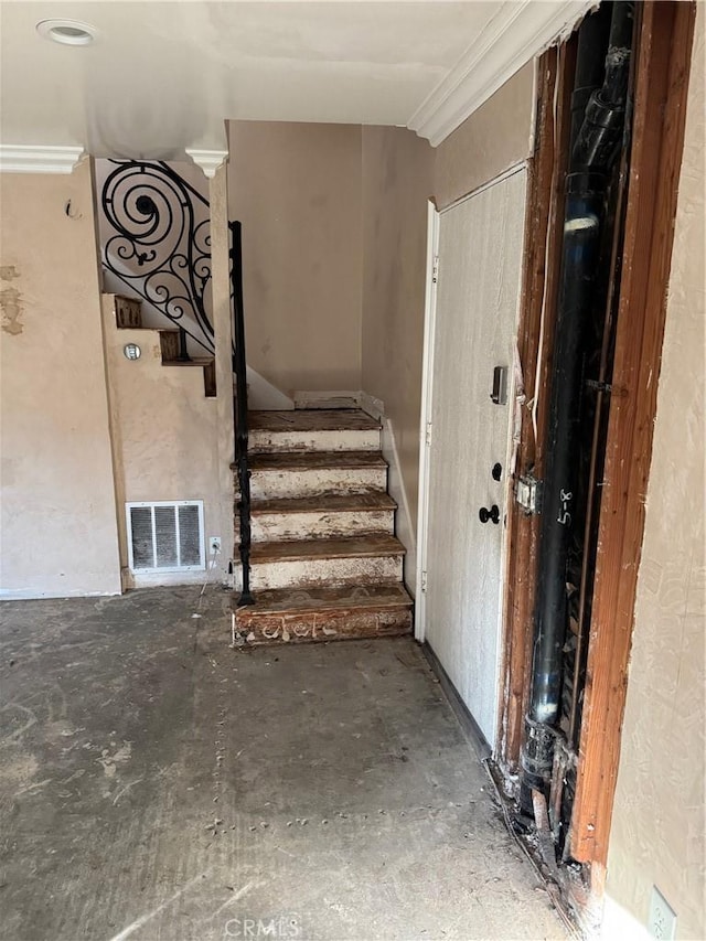 stairs featuring crown molding and visible vents