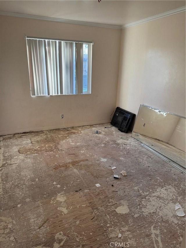 spare room featuring crown molding