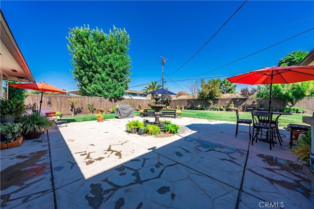 view of patio featuring outdoor dining area and a fenced backyard