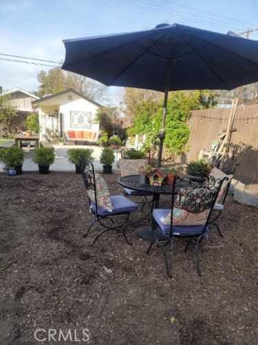 view of patio / terrace with outdoor dining space and fence