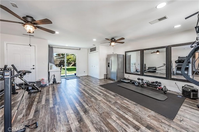 exercise area featuring visible vents, recessed lighting, and wood finished floors