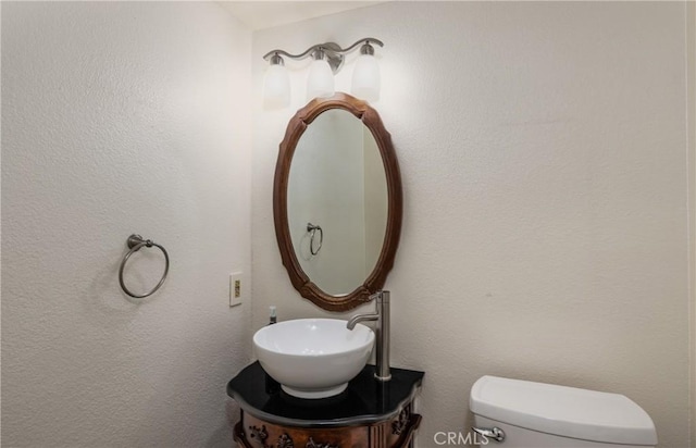 half bathroom with toilet and a sink