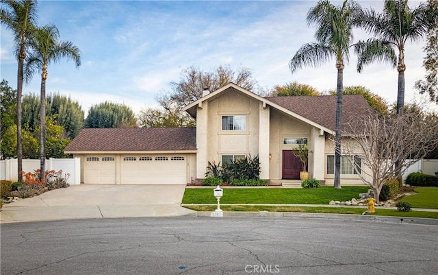 view of front facade featuring fence, an attached garage, stucco siding, concrete driveway, and a front lawn