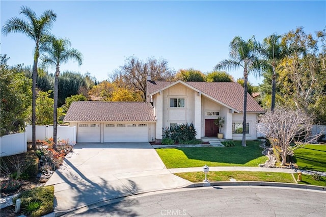 view of front of property with fence, stucco siding, concrete driveway, a front lawn, and a garage