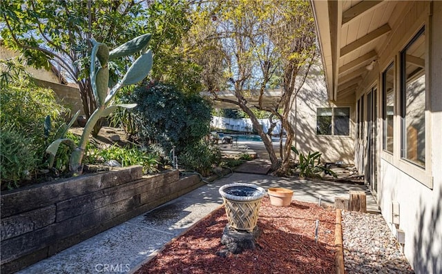 view of yard featuring a patio, a pool, and fence