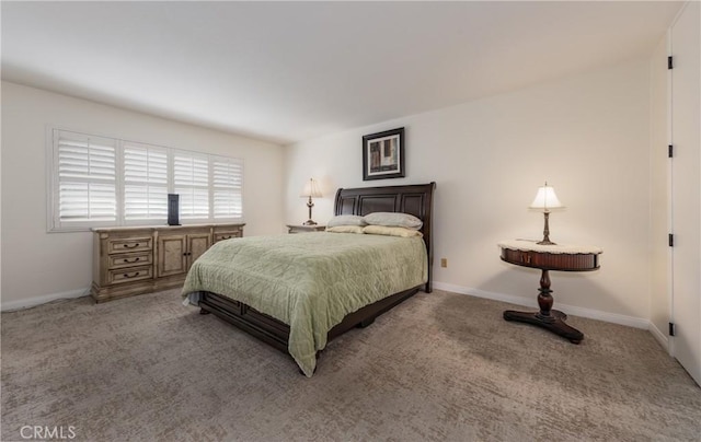 bedroom with baseboards and carpet flooring