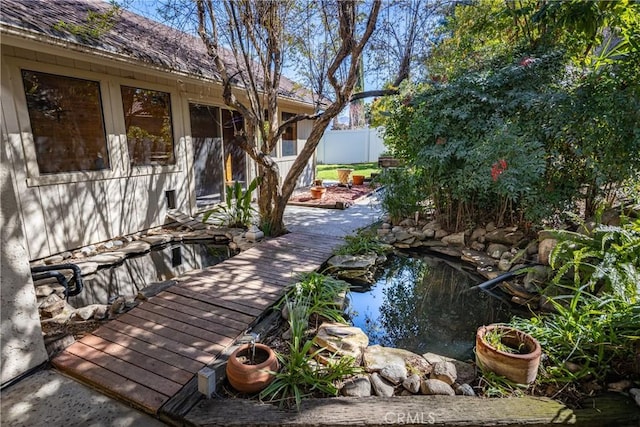 view of patio / terrace with an outdoor fire pit and fence