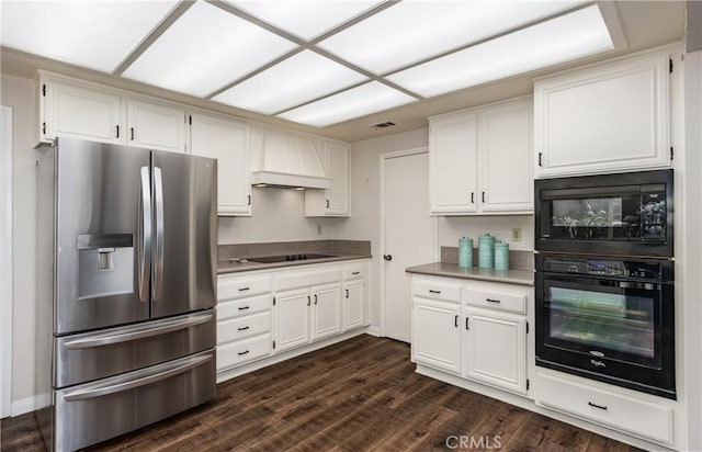 kitchen featuring custom exhaust hood, white cabinetry, black appliances, and dark wood-style flooring