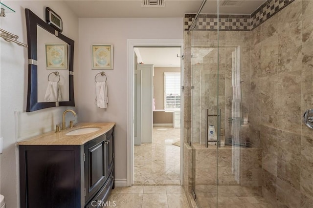 bathroom featuring visible vents, a shower stall, vanity, and baseboards