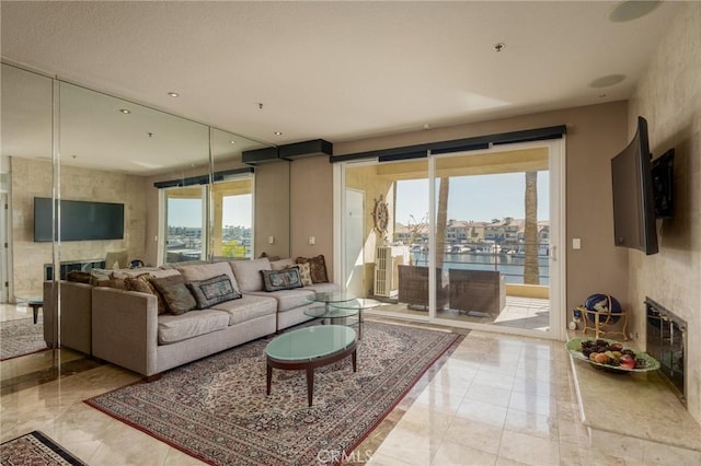 living room featuring marble finish floor and a fireplace