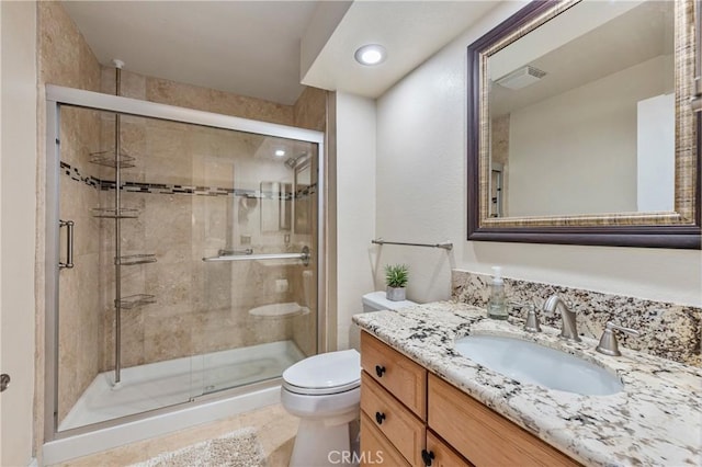 full bath featuring visible vents, a stall shower, toilet, and vanity