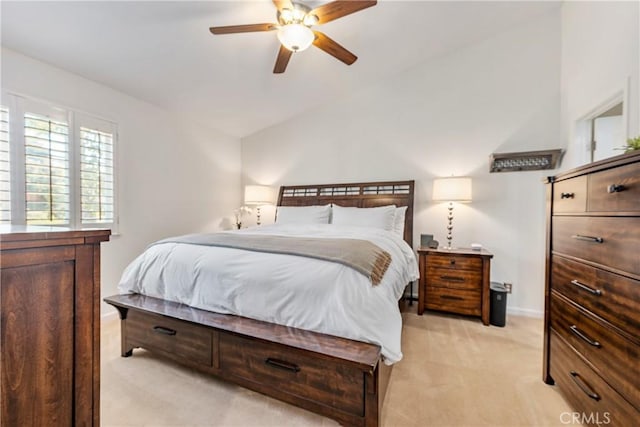 bedroom featuring baseboards, light colored carpet, ceiling fan, and vaulted ceiling