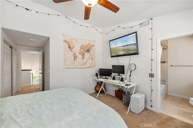 bedroom with connected bathroom, a ceiling fan, and baseboards