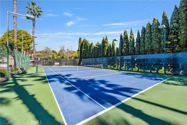 view of sport court featuring fence