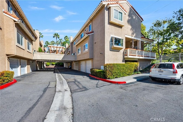 view of road featuring community garages