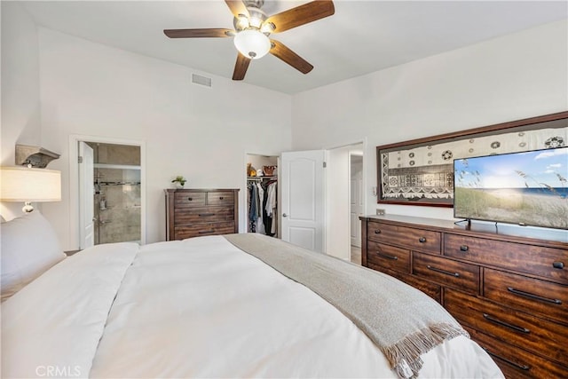 bedroom with visible vents, ensuite bathroom, a ceiling fan, a closet, and a spacious closet