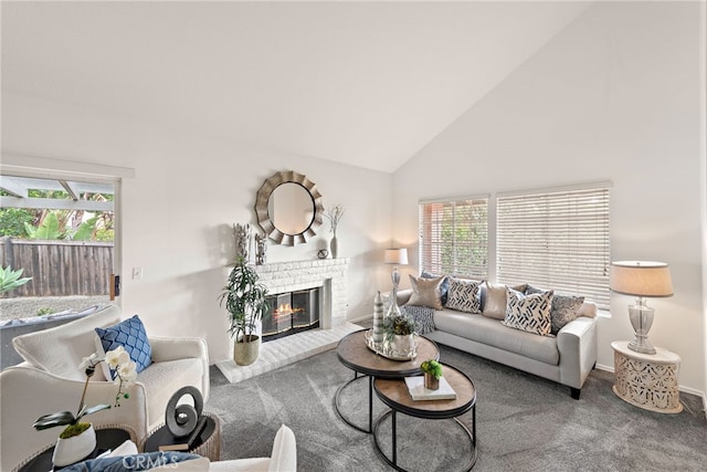 carpeted living room featuring plenty of natural light, a fireplace, baseboards, and high vaulted ceiling