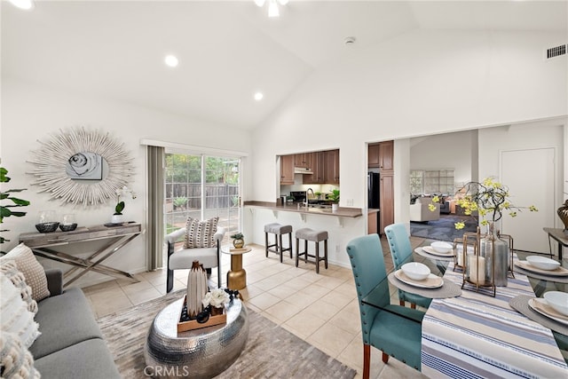 living room with light tile patterned flooring, recessed lighting, and high vaulted ceiling