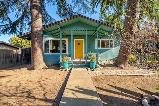 bungalow-style house with fence