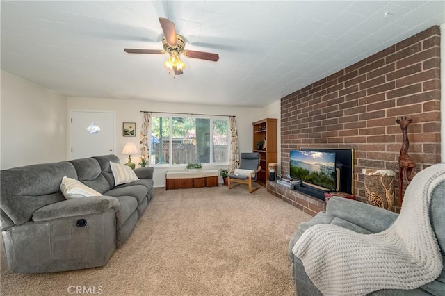 living area featuring carpet flooring, a fireplace, and a ceiling fan