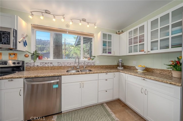 kitchen featuring white cabinets, stainless steel appliances, and a sink