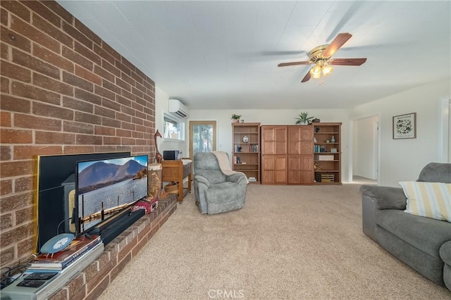 living room featuring a wall mounted air conditioner, carpet floors, a brick fireplace, and a ceiling fan