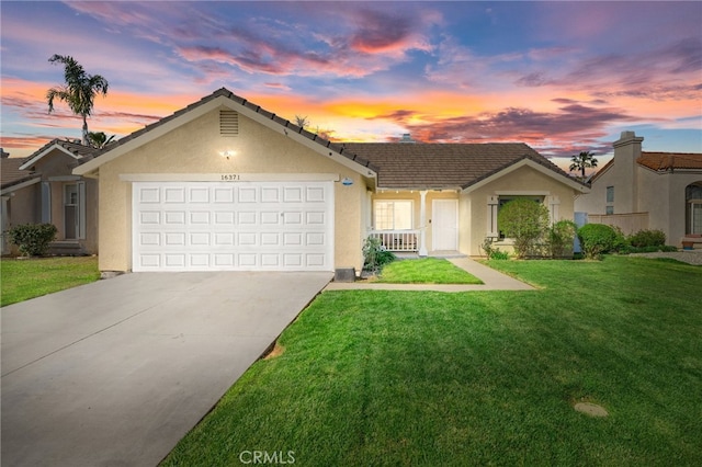 single story home featuring stucco siding, concrete driveway, a front yard, an attached garage, and a tiled roof