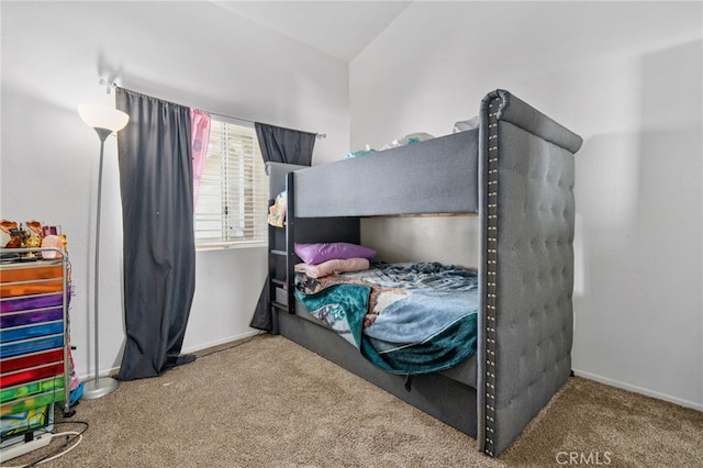 bedroom featuring baseboards and carpet