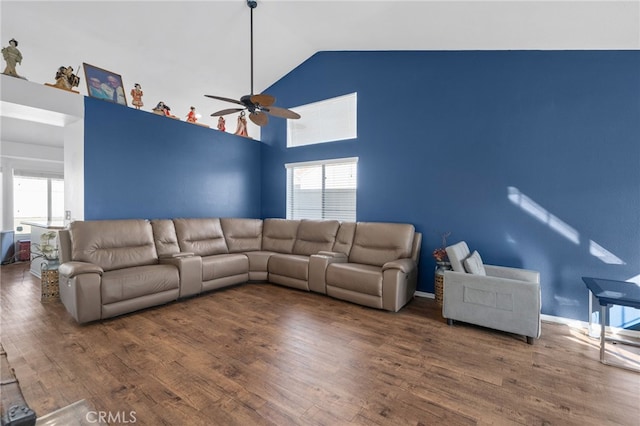 unfurnished living room with wood finished floors, a wealth of natural light, and high vaulted ceiling