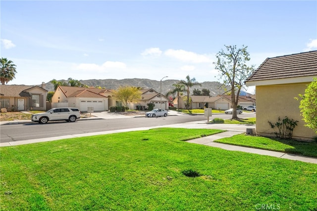 view of yard with a mountain view and a residential view