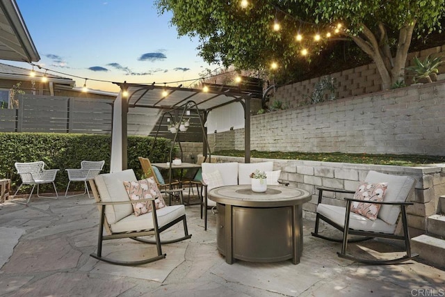 patio terrace at dusk featuring an outdoor hangout area and a fenced backyard