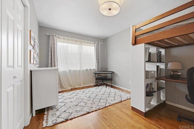 interior space with wood finished floors and baseboards