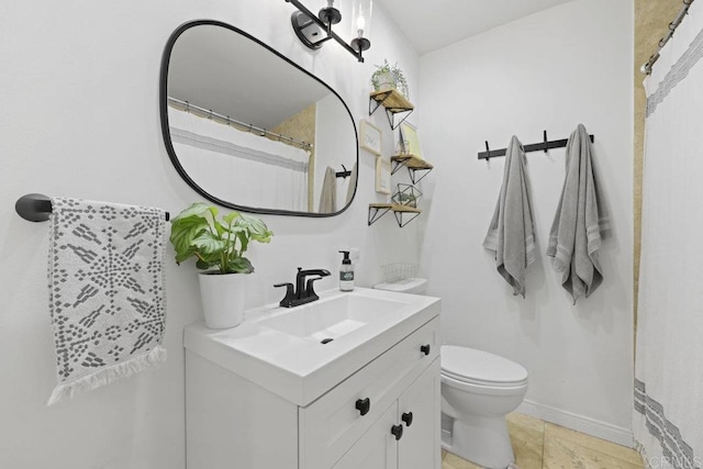 bathroom featuring toilet and vanity