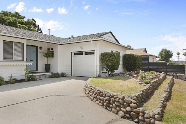 ranch-style house with stucco siding, concrete driveway, an attached garage, and fence