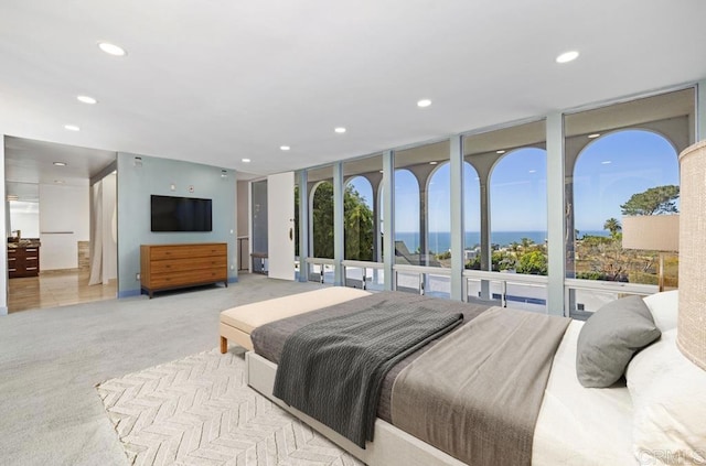 bedroom featuring recessed lighting, carpet, and expansive windows