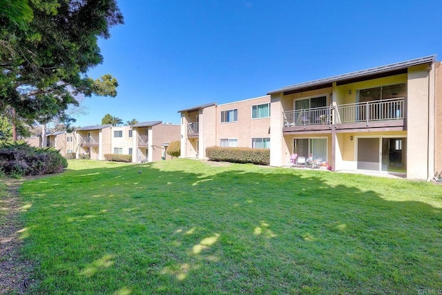 view of home's community with a yard