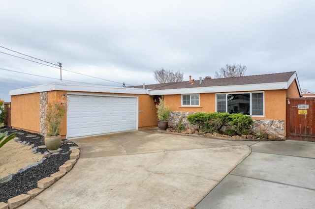 single story home featuring stone siding, stucco siding, driveway, and a garage