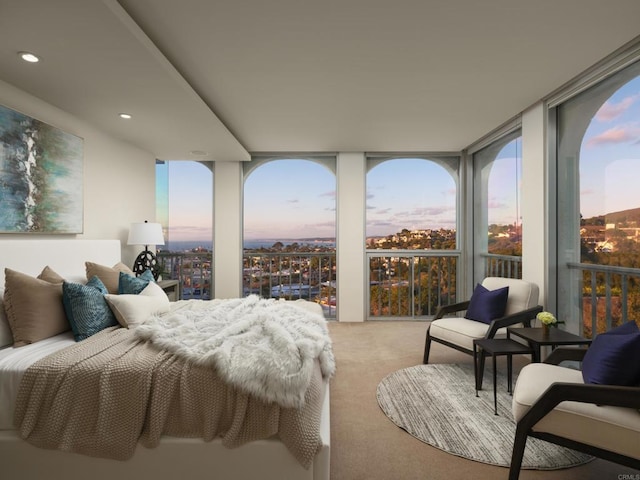 bedroom featuring a wall of windows, multiple windows, carpet floors, and recessed lighting