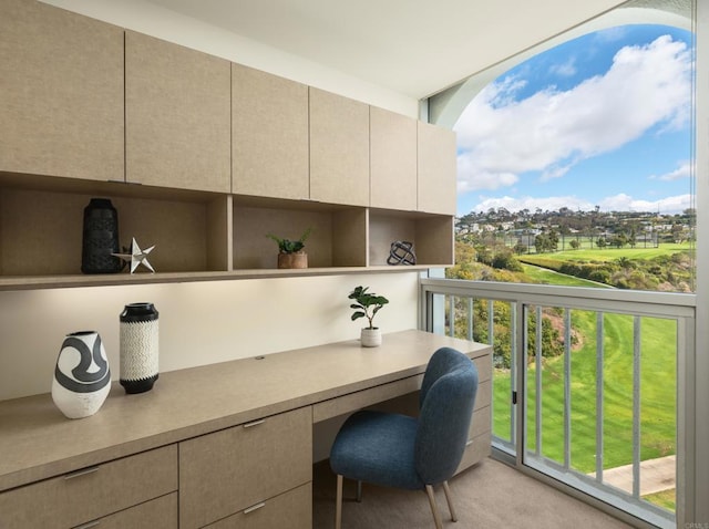 home office with light colored carpet and built in study area