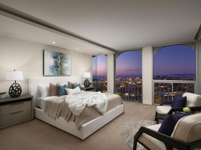 carpeted bedroom with a wall of windows