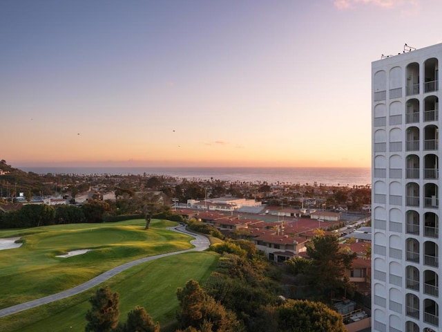 exterior space with view of golf course and a water view