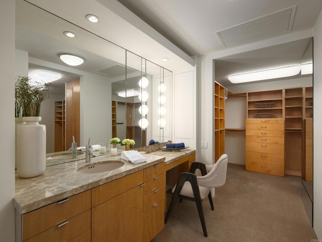 bathroom featuring a spacious closet, visible vents, recessed lighting, and vanity