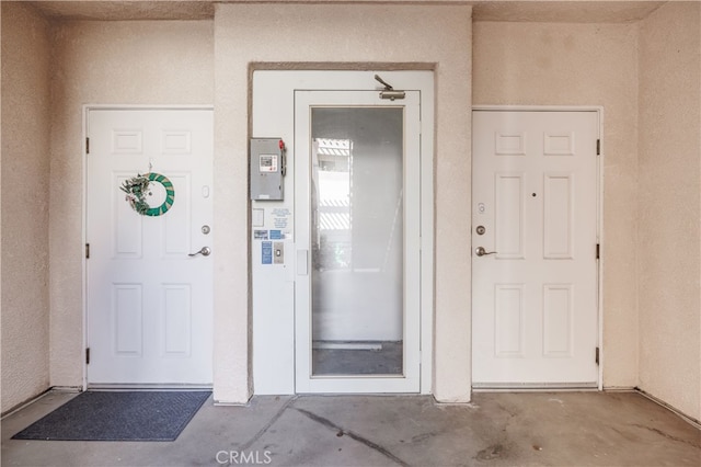 entrance to property featuring stucco siding